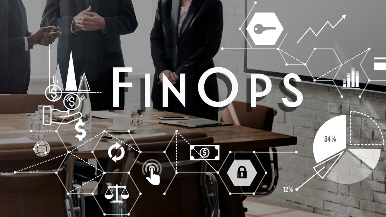 Business meeting with three people standing near a conference table, overlaid with financial and operational symbols and the word "FinOps.