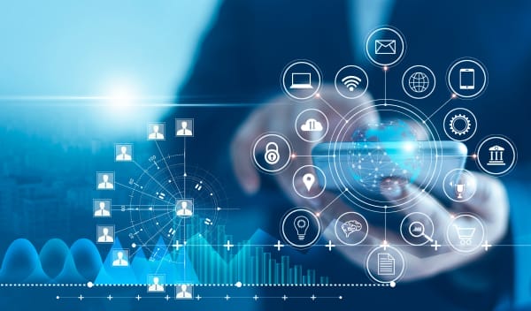 Person using a smartphone with overlay of technology and network icons, including cloud, email, and security symbols, against a digital blue background.